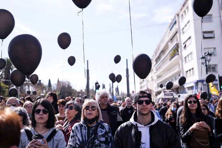 People obverse a minute of silence during a protest outside the Greek parliament in Athens on March 5, 2023.