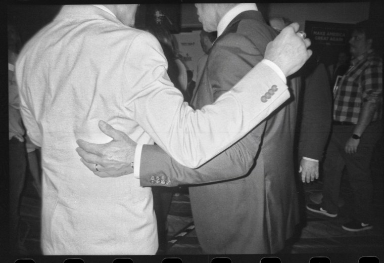 An attendee puts his arm around Miami Mayor Francis X. Suarez to pose for a picture in the media row at CPAC in National Harbor, Md., on March 3, 2023.