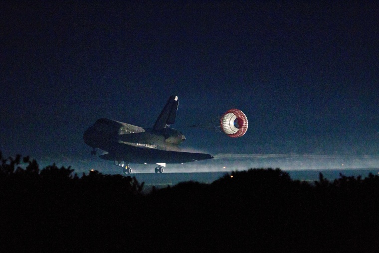 The drag chute is deployed as the Space Shuttle Atlantis lands at the Kennedy Space Center on July 21, 2011, the final mission of the NASA shuttle program. 