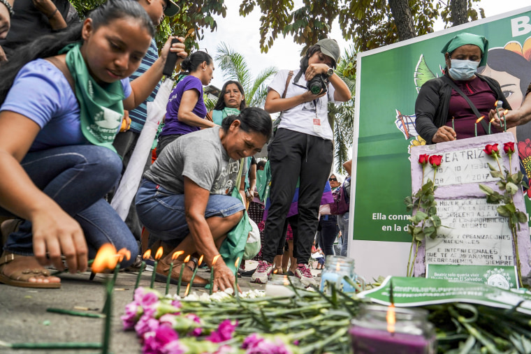 Demonstrators place candles on a memorial for Beatriz, a woman who died during pregnancy after being denied an abortion, in San Salvador, El Salvador, on Sept. 28, 2022.