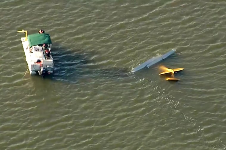 Emergency personnel work near the site of a midair collision of two planes in central Florida on Tuesday.