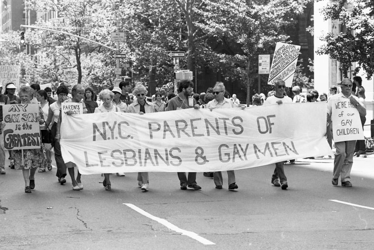 Jeanne Manford, behind the 'NYC' of the banner, and Dick Ashworth far right, with placard reading, 'We're proud of our gay children,'   march during the 1981 Gay Pride Parade in New York.