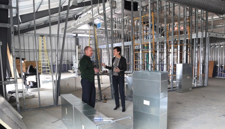 Northumberland High School Principal Travis Burns and correspondent Stephanie Gosk tour the school’s new multipurpose facility, which is still undergoing construction. 