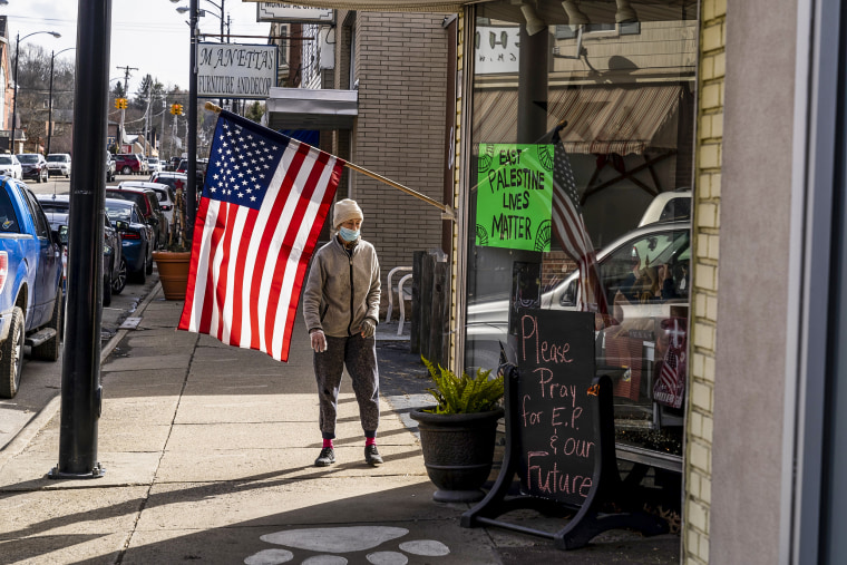 Image: A resident walks by an American flag on N. Market Street on Feb. 23, 2023 in East Palestine, Ohio.