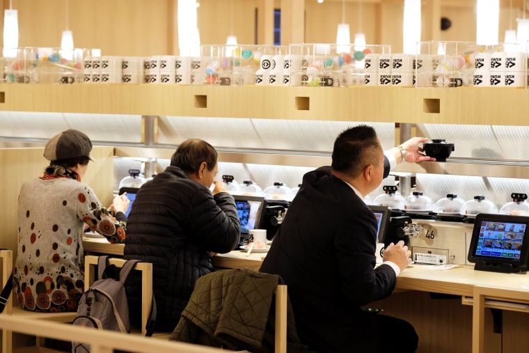 Customers dine at a conveyor belt sushi restaurant chain in Tokyo on Jan. 22, 2020.