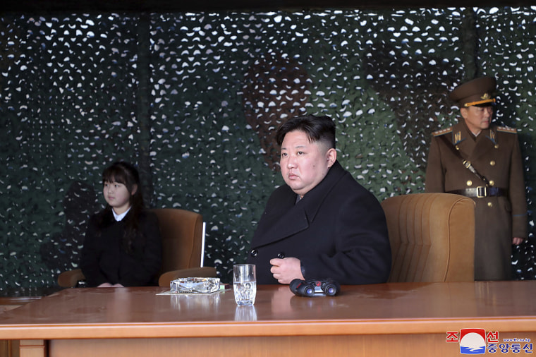 Kim Jong Un, with his daughter, inspects what the North Korean government says is an artillery drill at an undisclosed location in North Korea