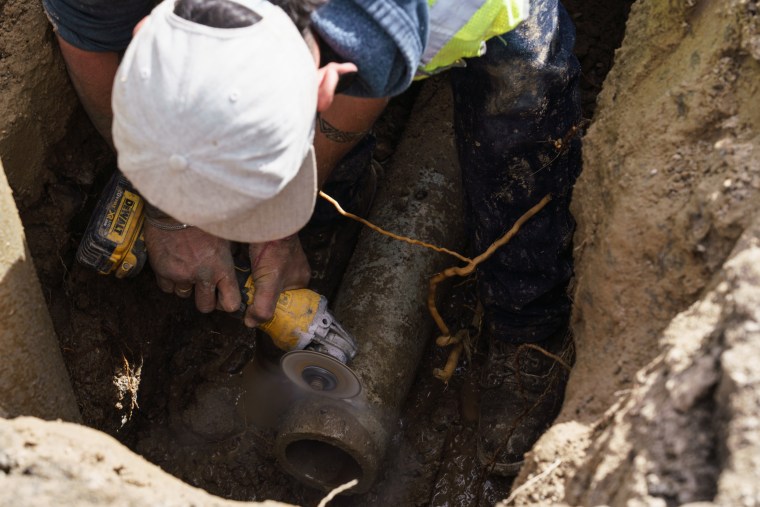 Water Department worker Andrew Curry, 34, repairs a pipe in Truth or Consequences, NM, where a new leak occurs almost every day.