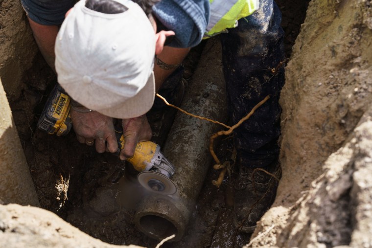 Water department worker Andrew Curry, 34, repairs a pipe in Truth or Consequences, N.M., where new leaks spring up nearly every day.