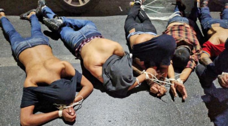 A photograph of five bound men facedown on the pavement accompanied a letter claiming to be from a Mexican drug cartel that included an apology after four Americans were abducted, two of whom died.