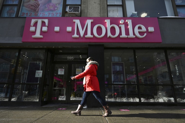 A woman walks past a T-Mobile retail store in New York, NY, January 31, 2022. It was reported that T-Mobile US Inc. plans to lay off company employees who are not fully vaccinated against the COVID-19 by April 2.