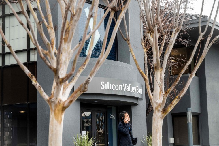 A pedestrian walks past the Silicon Valley Banks headquarters 