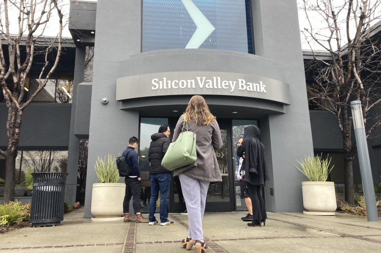 People stand outside an entrance to Silicon Valley Bank