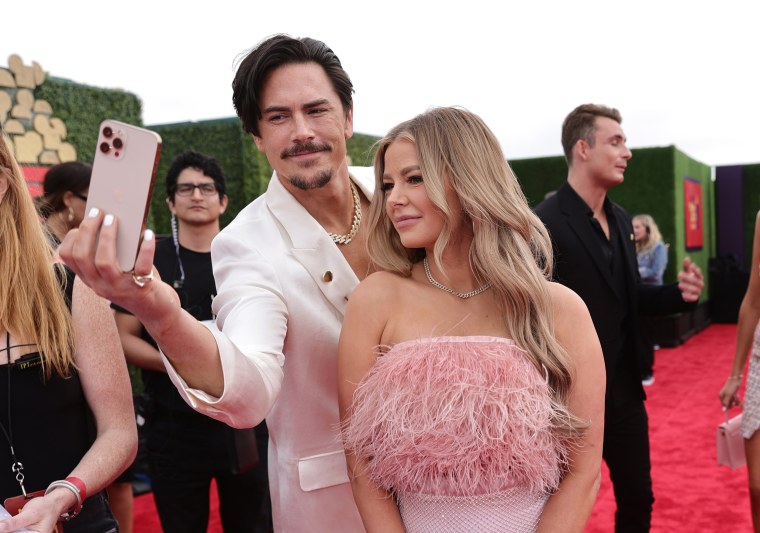 Tom Sandoval and Ariana Madix take a selfie on the red carpet at the MTV Movie & TV Awards