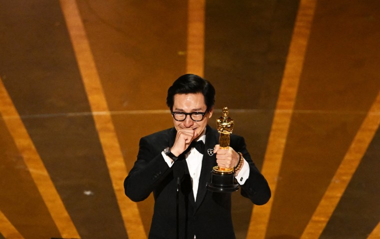 Ke Huy Quan accepts the Oscar for best actor in a supporting role during the Academy Awards in Hollywood, Calif.