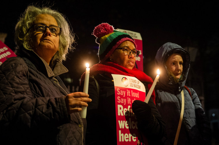 People attend a vigil outside Downing street to remember the four people who drowned in the English Channel the previous day and demand safe passage for refugees on Dec. 15, 2022, in London.