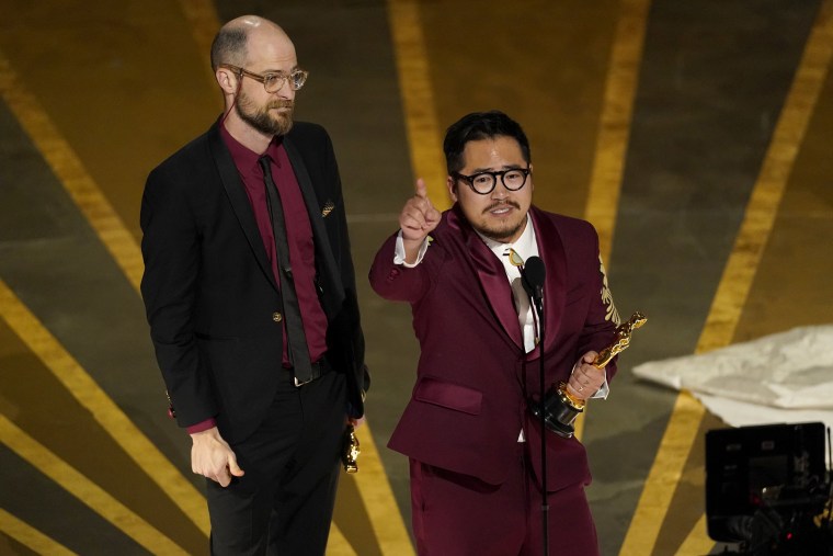 Daniel Scheinert, left, and Daniel Kwan accept the award for best original screenplay