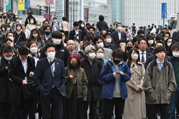 Japan's government eased its mask guidelines on March 13, recommending them only on crowded trains and in hospitals or care homes, but there was little sign residents were keen to unmask.