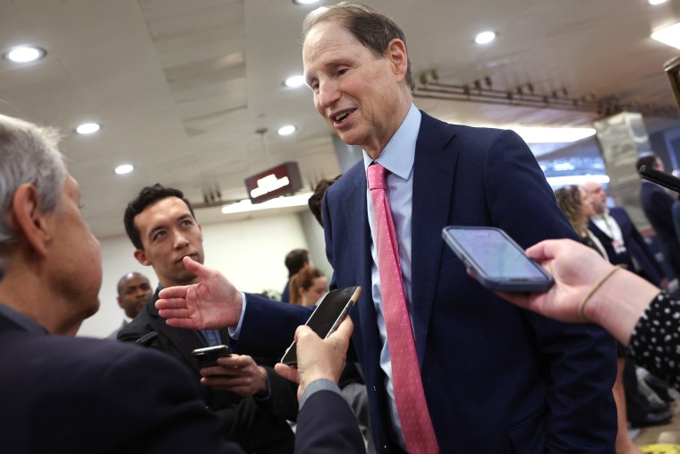 Mon.  Ron Wyden.  D-Ore., with reporters at the Capitol in Feb.  2023.
