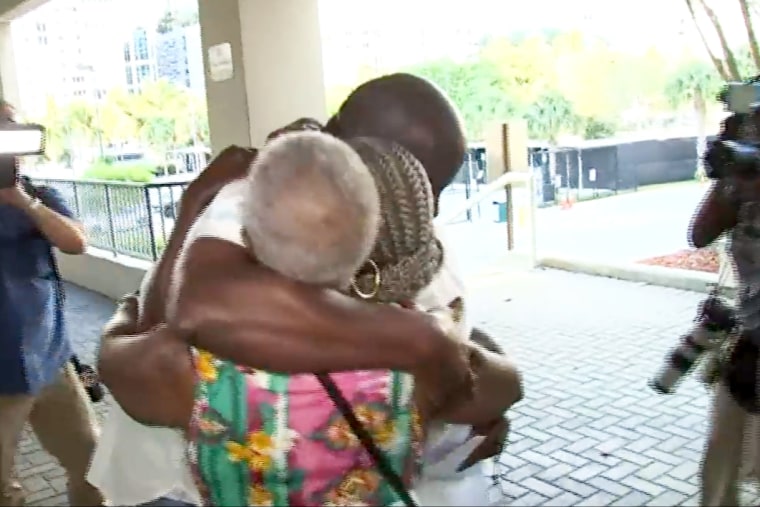 Sidney Holmes hugs relatives outside the Broward County Main Jail in Fort Lauderdale, Fla., on Monday.