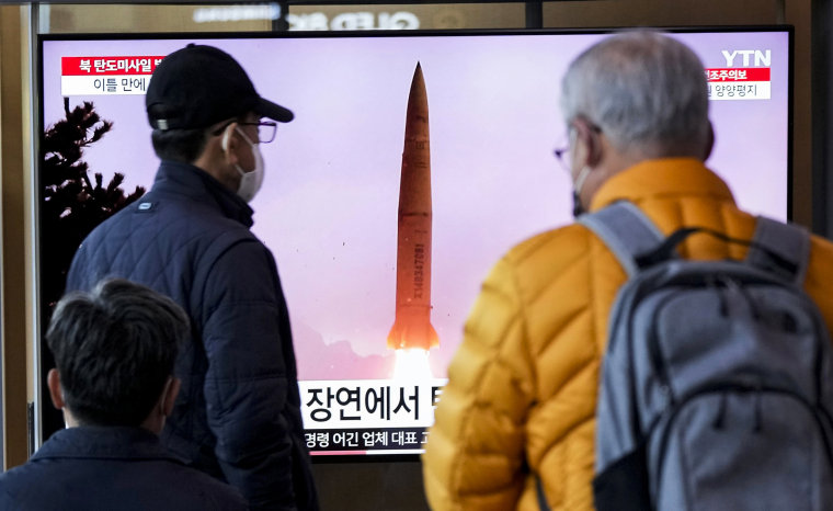 People watch a news broadcast showing a file image of North Korea's missile launch at the Seoul Railway Station in Seoul on March 16, 2023.