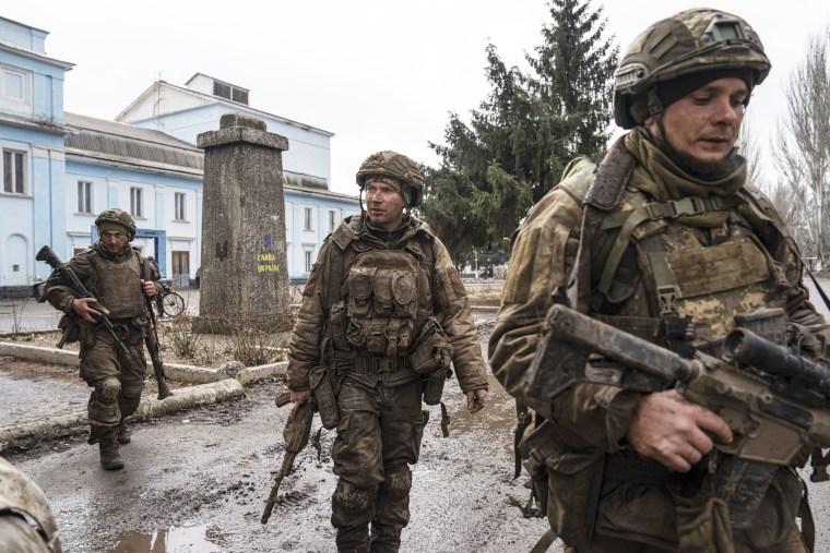 Ukrainian servicemen walk on a street in Chasiv Yar, Ukraine