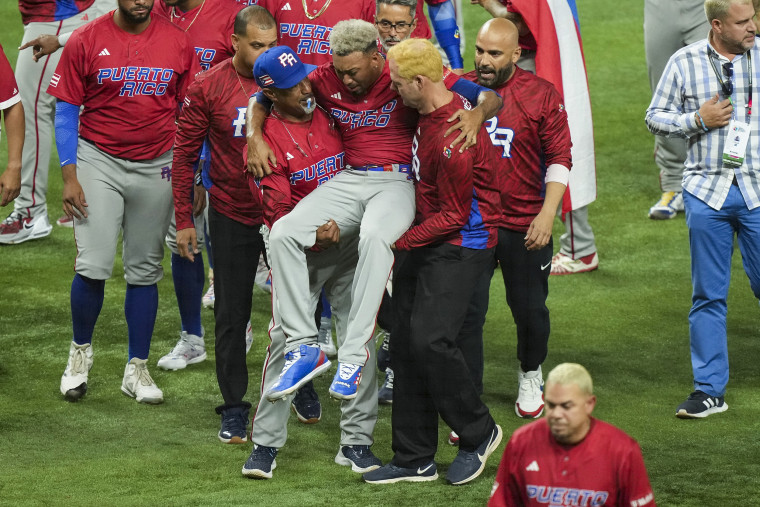 Edwin Diaz of Puerto Rico is helped off the field after being injured during the on-field celebration after defeating the Dominican Republic during the World Baseball Classic Pool D on March 15, 2023, in Miami.
