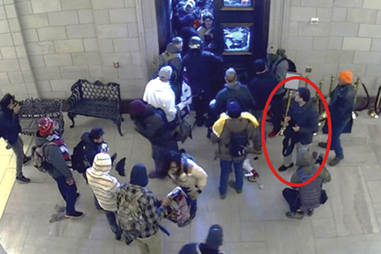 This image from the U.S. Capitol Police security video shows Elliot Resnick, circled in annotation by the Justice Department in the Statement of Facts supporting the arrest of Resnick, inside the U.S. Capitol by the East Rotunda doors on Jan 6. 2021. Resnick, a former top editor of an Orthodox Jewish newspaper in New York City, was arrested Thursday, March 16, 2023, on charges that he interfered with police officers who were trying to protect the U.S. Capitol during the Jan. 6 riot.
