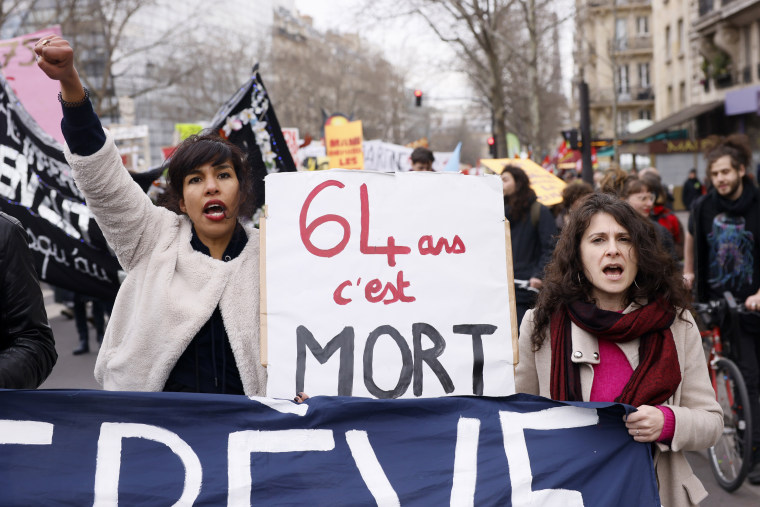 Protesters hold a sign reading "64 is dead" during a demonstration against the government's plan to raise the retirement age to 64, in Paris, France