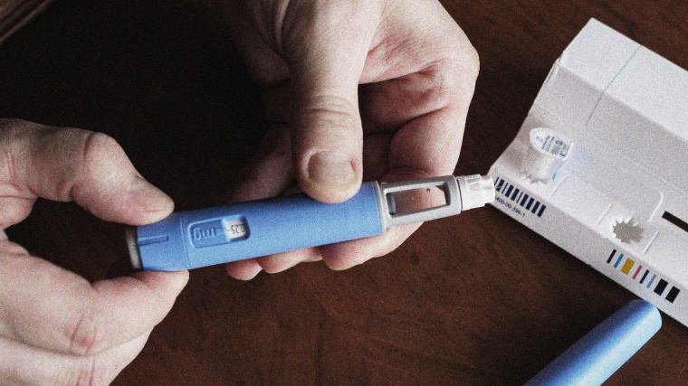 A person prepares a semaglutide  injection