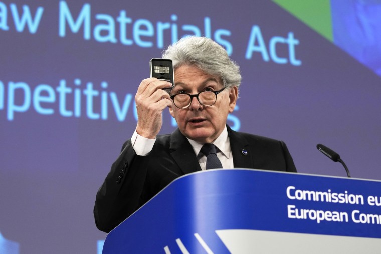 Thierry Breton holds up raw materials during a media conference at EU headquarters