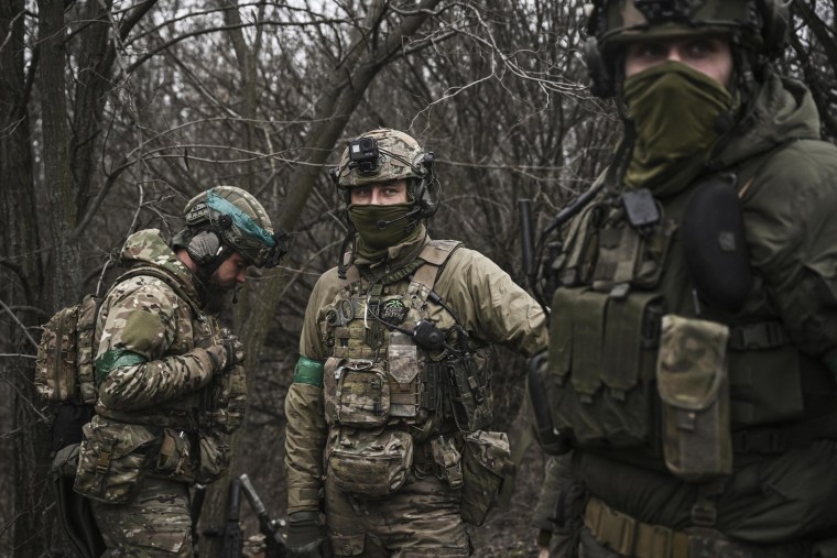 Ukrainian special unit members stands in the woods, near Bachmut, in the region of Donbas, on March 15, 2023. 