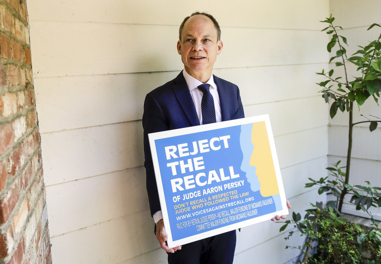 Judge Aaron Persky holds a sign opposing his recall in Los Altos Hills, Calif., on May 15, 2018.