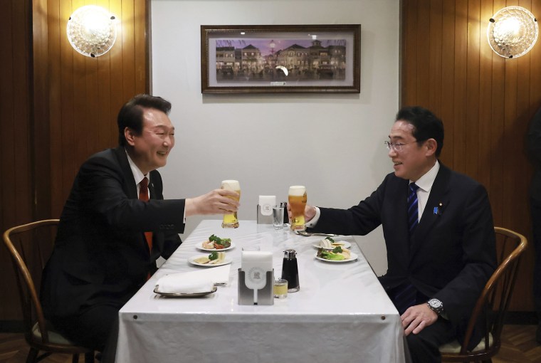 South Korean President Yoon Suk Yeol, left, and Japanese Prime Minister Fumio Kishida make a toast at Rengatei restaurant in Tokyo