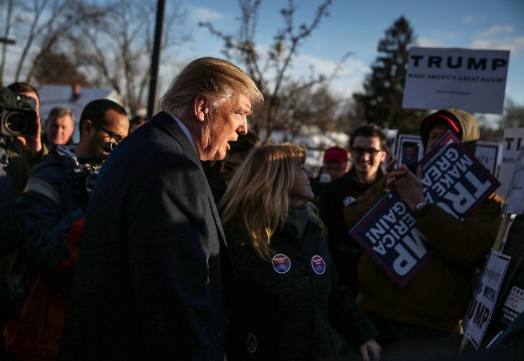 Republican presidential candidate Donald Trump greets people as he visits a polling station as voters cast their primary day ballots on Feb. 9, 2016 in Manchester, N.H.
