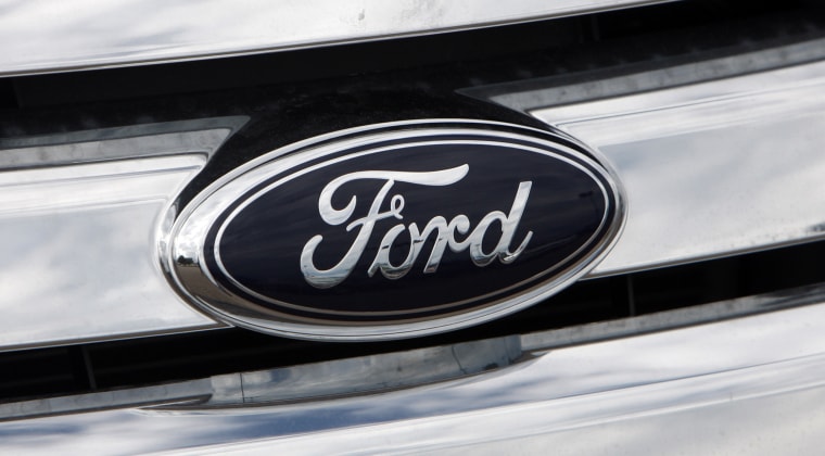 A Ford logo shines off the grille of a vehicle