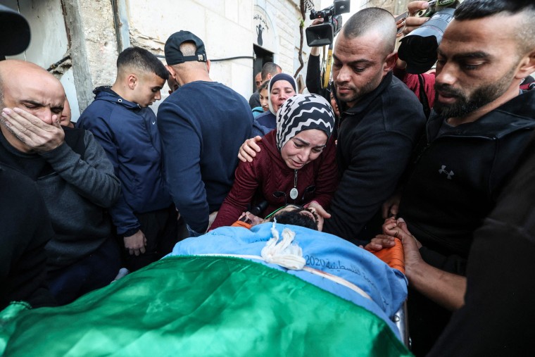 Image: Relatives mourn by the bodies of Palestinians killed in an Israeli raid earlier in the day, during their funeral in Jenin city in the occupied West Bank, on March 16, 2023.