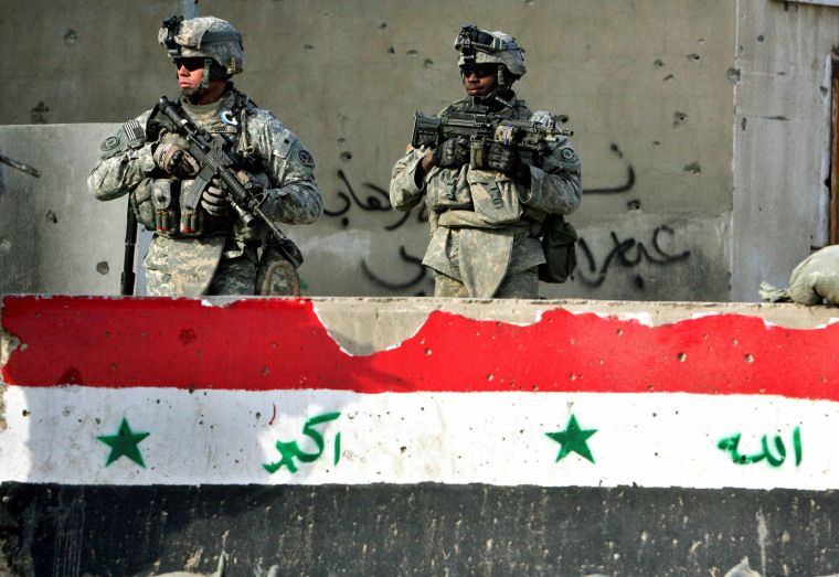 Two U.S. soldiers patrol a neighborhood in Baghdad