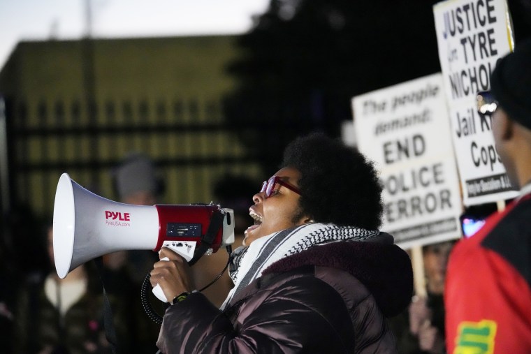 Amber Sherman speaks through a megaphone during a protest of the police killing of Tyre Nichols