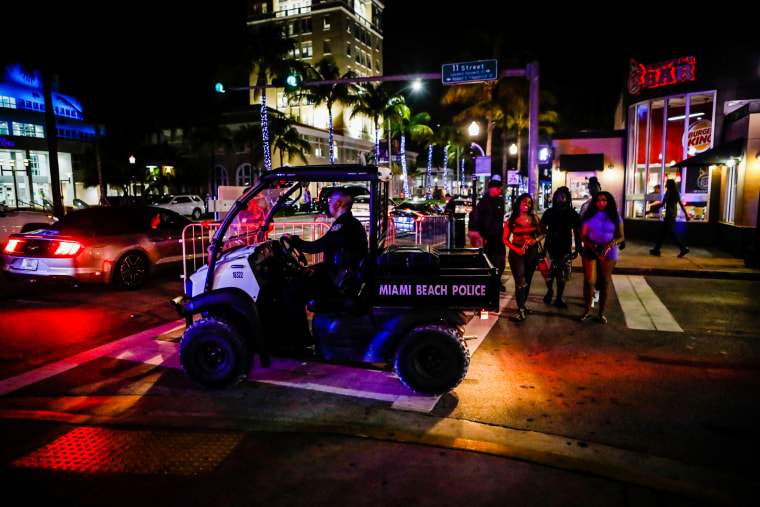 A Miami Beach Police officer exits a closed road during spring break on March 24, 2022.