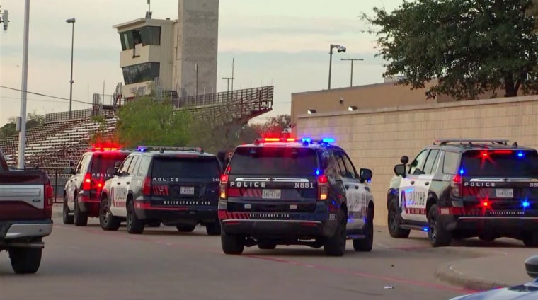 Arlington Police investigate a shooting outside Lamar High School, Monday, March 20, 2023.