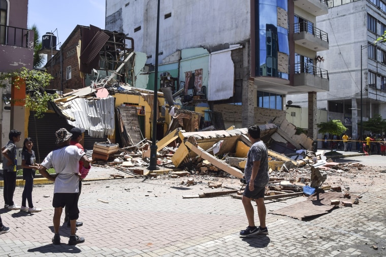 Image: Residents look at a building that collapsed after an earthquake on March 18, 2023.