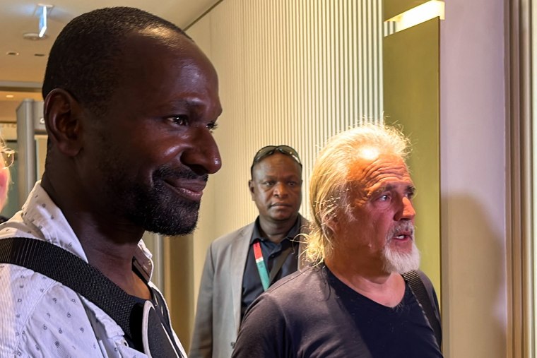French journalist Olivier Dubois, left, freed nearly two years after he was kidnapped by the Support Group for Islam and Muslims in Mali, and U.S. aid worker Jeffery Woodke, freed after being kidnapped in October 2016 in Niger, arrive at Diori Hamani International Airport in Niamey, Niger, on March 20, 2023.
