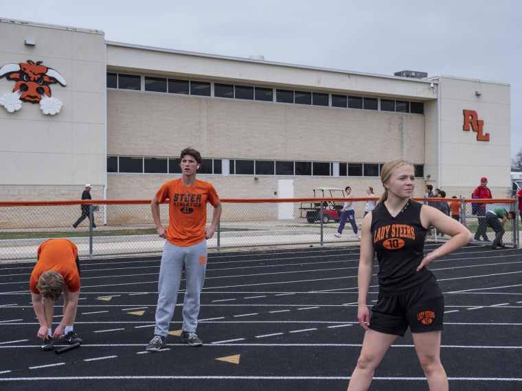 Members of Robert Lee ISD’s middle and high schools warm up before a track meet in Robert Lee, Texas on March 9, 2023.