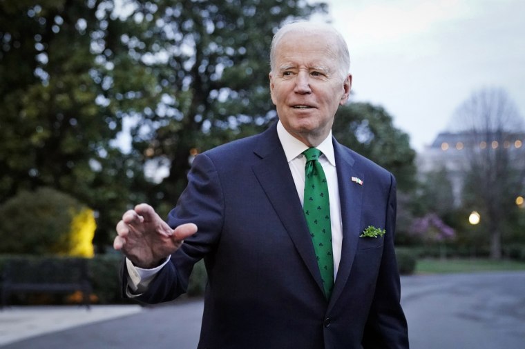 President Joe Biden waves as he walks to Marine One at the White House on March 15, 2023.
