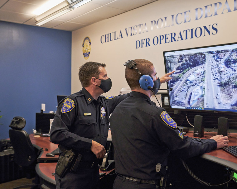 Capt. Don Redmond, left, and Officer Evan Linney monitor a police drone operation from the Chula Vista Police Department's command center, in Chula Vista, Calif., on Nov. 11, 2020.