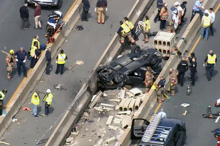 Emergency personnel work the scene of a crash on I-695 in Baltimore County which has left multiple people dead, on Wednesday.