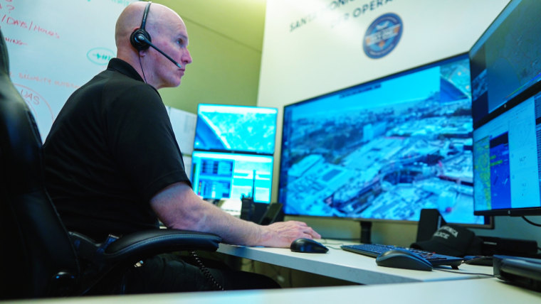 Officer Peter Lashley controls the department’s drone at a command center inside the police station.