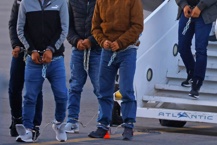 Migrants, transferred from Plattsburgh, N.Y., disembark from a plane in El Paso, Texas, on March 21, 2023.