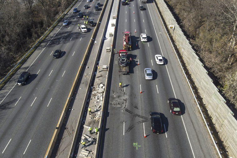 Image: Emergency personnel work at the scene of a fatal crash along Interstate 695 on March 22, 2023, near Woodlawn, Md.