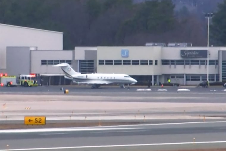 An emergency vehicle is parked near the Bombardier Challenger 300 that diverted to Bradley International Airport in Windsor Locks, Conn., on March 3.
